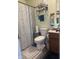 Bathroom featuring a toilet, sink, shower with shower curtain, and tile floors at 10793 Walnut Grove Bnd, Camby, IN 46113