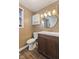 Updated bathroom with modern vanity, decorative mirror, and vinyl floor at 1131 Madeira St, Indianapolis, IN 46203