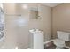 Bathroom with a pedestal sink, toilet, and modern vanity mirror at 1131 Madeira St, Indianapolis, IN 46203