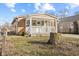 Inviting home featuring a covered front porch with white railing and a front yard with a tree stump at 1131 Madeira St, Indianapolis, IN 46203
