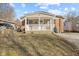 Charming home featuring a cozy front porch with white railings and a combination of brick and siding exterior at 1131 Madeira St, Indianapolis, IN 46203