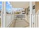 Inviting covered front porch with white railing providing a view of the neighborhood at 1131 Madeira St, Indianapolis, IN 46203