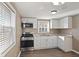 Bright kitchen featuring white cabinets, stainless appliances, and ample natural light at 1131 Madeira St, Indianapolis, IN 46203