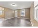 Inviting living room with hardwood flooring, and a well-lit entry door at 1131 Madeira St, Indianapolis, IN 46203