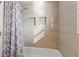 New shower with tiled walls, built-in shelving, and new shower head at 1131 Madeira St, Indianapolis, IN 46203