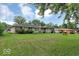 Expansive backyard featuring a well-maintained lawn and lush trees, offering privacy and space at 120 E Beechwood Ln, Indianapolis, IN 46227