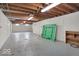 Spacious unfinished basement with painted walls, exposed beams and gray concrete floor at 120 E Beechwood Ln, Indianapolis, IN 46227