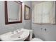 Cozy bathroom with vintage-style fixtures, a pedestal sink and natural light from window at 120 E Beechwood Ln, Indianapolis, IN 46227