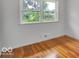 Bedroom with hardwood flooring, neutral walls, and a sunlit window at 120 E Beechwood Ln, Indianapolis, IN 46227