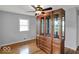 Bedroom with hardwood floors, natural light, and a large, stylish china cabinet at 120 E Beechwood Ln, Indianapolis, IN 46227