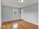 This bedroom is bright and features hardwood flooring and a window at 120 E Beechwood Ln, Indianapolis, IN 46227