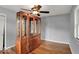 Bright bedroom with hardwood floors featuring natural light and large china cabinet at 120 E Beechwood Ln, Indianapolis, IN 46227
