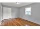 This bedroom has hardwood floors, a window, and closet with sliding doors at 120 E Beechwood Ln, Indianapolis, IN 46227