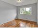 Bright bedroom with hardwood floors, natural light, and neutral wall paint at 120 E Beechwood Ln, Indianapolis, IN 46227