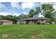 View of the home, featuring the front lawn, stone facade and attached garage at 120 E Beechwood Ln, Indianapolis, IN 46227