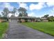 View of the home featuring a driveway, attached garage and well-maintained lawn at 120 E Beechwood Ln, Indianapolis, IN 46227