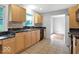 Traditional kitchen with wood cabinets, black granite countertops and tile flooring at 120 E Beechwood Ln, Indianapolis, IN 46227