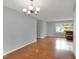Living room features hardwood flooring, modern lighting, and view into the kitchen area at 120 E Beechwood Ln, Indianapolis, IN 46227