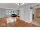 Spacious living room featuring hardwood flooring, large windows, and a leather couch set at 120 E Beechwood Ln, Indianapolis, IN 46227