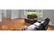Spacious living room featuring hardwood flooring, large windows, and a leather couch set at 120 E Beechwood Ln, Indianapolis, IN 46227