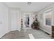 View of a dining area with wood-look floors, a rocking chair, and an open doorway to another room at 1205 S Dequincy St, Indianapolis, IN 46203