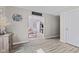 Open hallway with wood-look floors, leading into a carpeted living room with natural light at 1205 S Dequincy St, Indianapolis, IN 46203