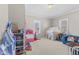 Spacious playroom featuring neutral walls, carpeted floors, and an array of toys at 1205 S Dequincy St, Indianapolis, IN 46203