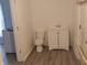 Cozy bathroom featuring a white toilet, sink with vanity, and modern flooring at 1311 N Olney St, Indianapolis, IN 46201