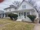 Charming two-story white home featuring a inviting front porch at 1311 N Olney St, Indianapolis, IN 46201