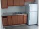 Standard kitchen with basic wood cabinets and white refrigerator at 1311 N Olney St, Indianapolis, IN 46201