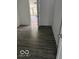 Bare room offering durable gray flooring and an entrance to a balcony at 1311 N Olney St, Indianapolis, IN 46201