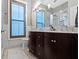 Elegant bathroom with double vanity, dark wood cabinets, marble countertops, and tiled floors at 1471 N Delaware St, Indianapolis, IN 46202