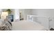 Modern bedroom with white walls and small fridge, looking into bathroom at 1471 N Delaware St, Indianapolis, IN 46202