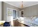 Elegant bedroom features hardwood floors, chandelier, and access to an additional level at 1471 N Delaware St, Indianapolis, IN 46202
