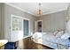 Elegant bedroom features hardwood floors, chandelier, and recessed built-in shelving unit at 1471 N Delaware St, Indianapolis, IN 46202