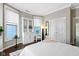 Bright bedroom with large windows, hardwood floors, stylish decor, and a built-in shelving unit at 1471 N Delaware St, Indianapolis, IN 46202