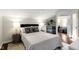 Modern bedroom featuring a mini-fridge, bedside tables, and neutral colored walls at 1471 N Delaware St, Indianapolis, IN 46202