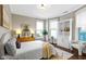Bright bedroom features large windows, hardwood floors, stylish decor, and a cozy seating area at 1471 N Delaware St, Indianapolis, IN 46202