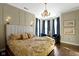 Inviting bedroom with a chandelier, large windows with blue curtains, and seating at 1471 N Delaware St, Indianapolis, IN 46202