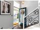 Bright entryway featuring stylish staircase, frosted glass door and decorative wreath creates an inviting space at 1471 N Delaware St, Indianapolis, IN 46202