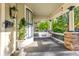 Inviting front porch featuring a swing, decorative plants, and charming architectural details at 1471 N Delaware St, Indianapolis, IN 46202
