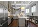 Updated kitchen with stainless steel appliances, kitchen island with marble countertop, and coffered ceiling at 1471 N Delaware St, Indianapolis, IN 46202