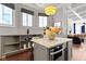 Stylish kitchen with kitchen island with marble countertop, stainless steel appliances, and bright natural light at 1471 N Delaware St, Indianapolis, IN 46202