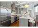 Modern kitchen with stainless steel appliances, kitchen island with seating, and coffered ceiling at 1471 N Delaware St, Indianapolis, IN 46202