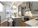 Contemporary kitchen featuring stainless steel appliances, kitchen island with marble countertop, and coffered ceiling at 1471 N Delaware St, Indianapolis, IN 46202