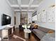 Bright living room featuring modern decor, coffered ceiling, and hardwood floors at 1471 N Delaware St, Indianapolis, IN 46202