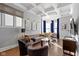 Spacious living room features hardwood floors, coffered ceiling, and large windows with custom drapes at 1471 N Delaware St, Indianapolis, IN 46202