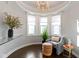 Sunlit sitting area with bay window, chandelier, stylish decor, and dark hardwood floors at 1471 N Delaware St, Indianapolis, IN 46202