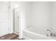 A modern bathroom with a tub and shower area enclosed by a sleek glass door, offering a clean and stylish design at 1585 N Regatta Dr, Greenfield, IN 46140