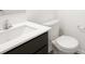 Bathroom features a white toilet, toilet paper holder, and a sink with a white countertop and dark brown cabinet at 1585 N Regatta Dr, Greenfield, IN 46140